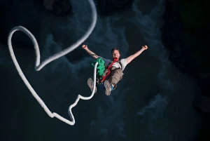 Smiling man mid air during bungee jump